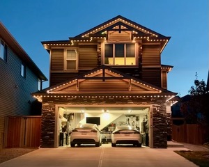 Home facade and garage lit at night