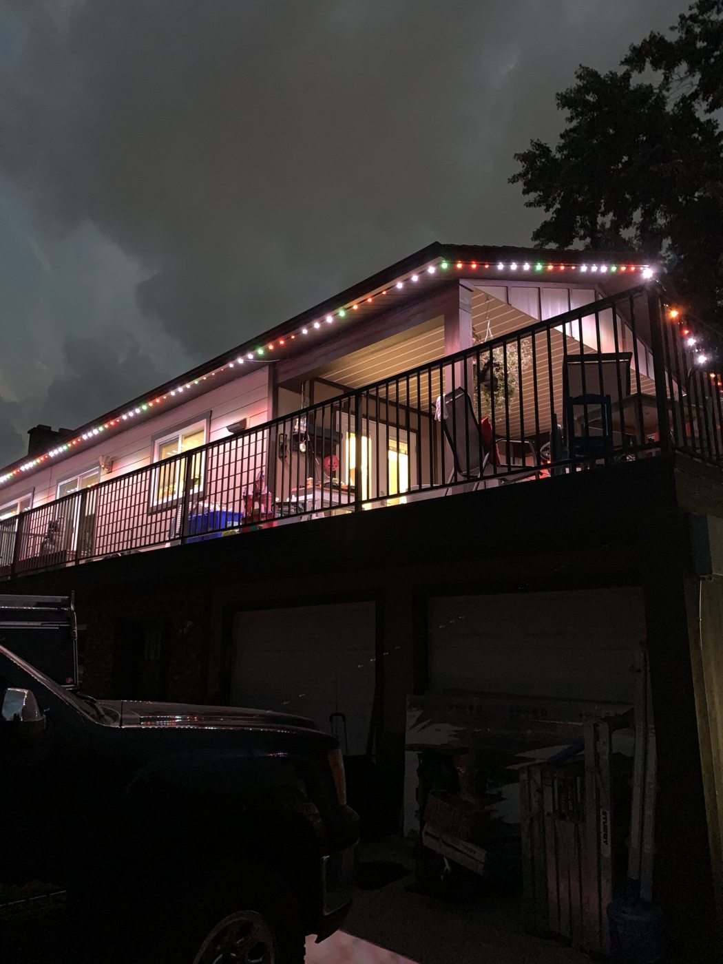 Home with lit deck and perimeter lighting